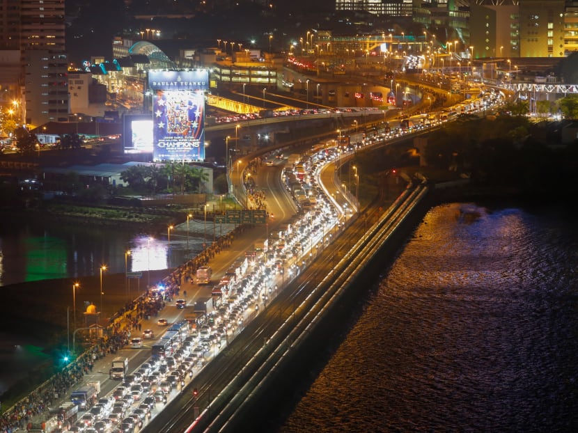 Commuters take the Woodlands Causeway to Singapore from Johor on March 17 before Malaysia imposes a lockdown on travel due to the coronavirus outbreak. Commuters take the Woodlands Causeway to Singapore from Johor on March 17 before Malaysia imposes a lockdown on travel due to the coronavirus outbreak.