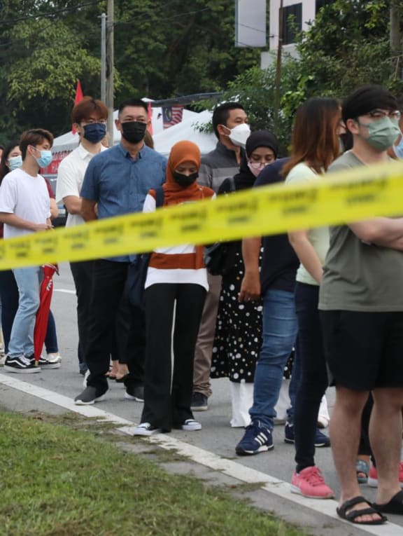 People waiting in line outside a polling centre in Tambun to cast their votes in Malaysia’s 15th general election on Nov 19, 2022.