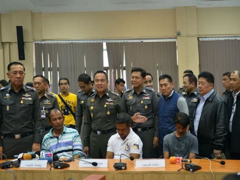 Police chief Somyot Pumpunmuang, standing with the raised hand, shows three suspects in the Rohingya death case in Songkhla province on Monday. Sitting from left, local administrators Asan Inthathanoo, Ror-en Sonyalae and Alee Lamoh denied all charges. Photo: Bangkok Post