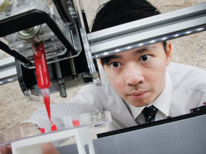 Co-founder and director of Bio3D Technologies, Mr Fan Mingwei, who is a fresh graduate of NTU, with the Life-Printer ‘X’, executing a simulation print of a blood vessel using red bio-gel. PHOTO: DON WONG