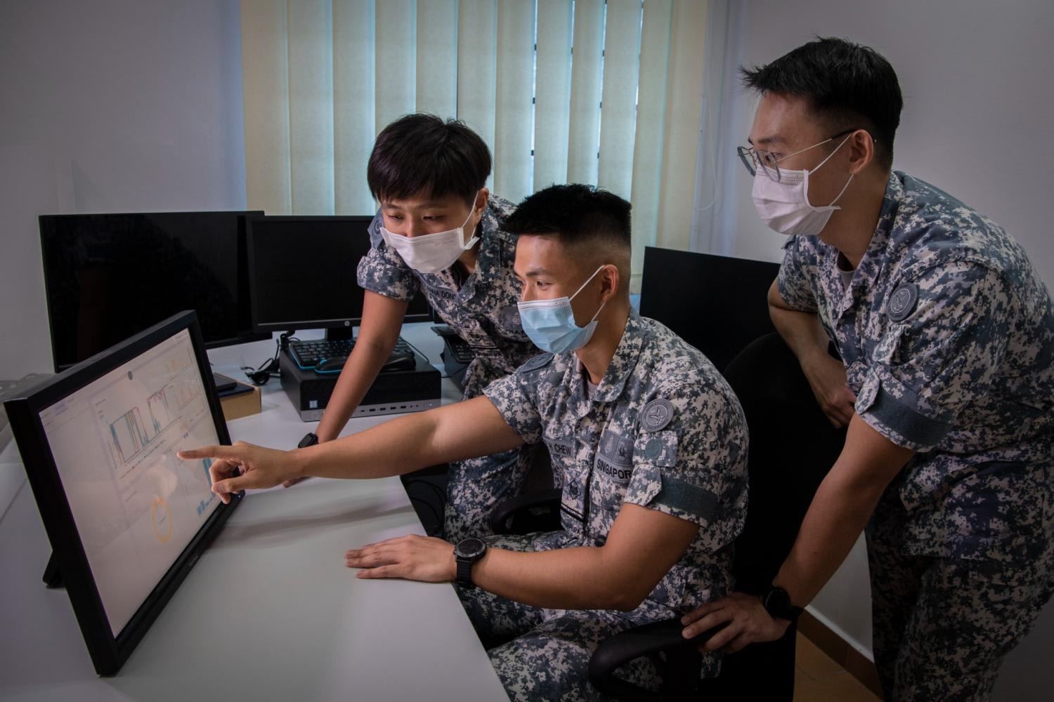 Military personnel analysing sound readings from a sensor as part of predictive maintenance for the Navy's vessels.