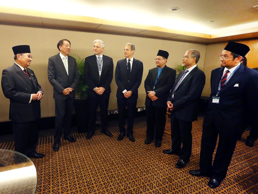 From left: CEO of The Soufan Group and Former US FBI Supervisory Special Agent Ali Soufan; Brunei's Minister for Home Affairs Pehin Dato Badaruddin Othman; Singapore Deputy Prime Minister Teo Chee Hean; Secretary of Australia's Attorney General Department Chris Moraitis; US Under Secretary of State for Public Diplomacy and Public Affairs Richard Stengel; Mufti of Singapore's Islamic Religious Council Dr Mohamed Fatris Bakaram; Minister in the Prime Minister's Office Masagos Zulkifli Bin Masagos Mohamad and Lecturer of Islamic Studies at the Faculty of Theology at Oxford University Shaykh Dato' Dr Afifi al-Akiti at the East Asia Summit (EAS) Symposium on Religious Rehabilitation and Social Reintegration in Singapore at The Ritz-Carlton, Millenia Singapore yesterday. Photo: Ernest Chua