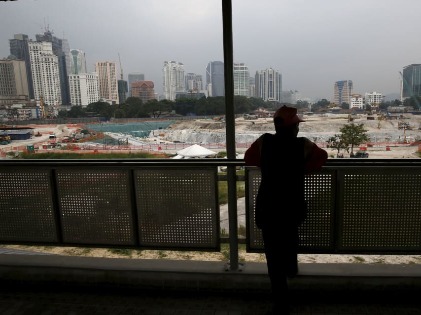 A man looks out at the 1 Malaysia Development Berhad (1MDB) flagship Tun Razak Exchange development in Kuala Lumpur, Malaysia, July 3, 2015. Photo: Reuters