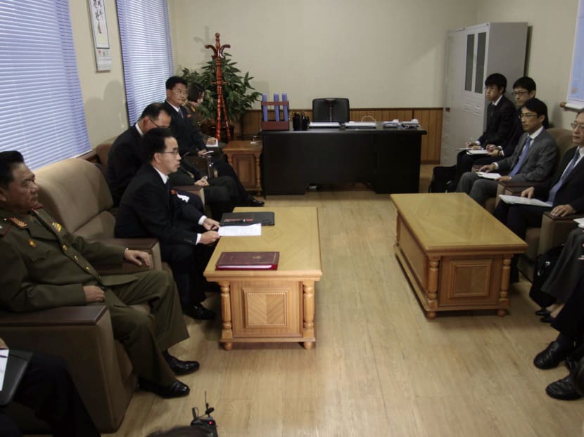 Mr Kim Hyon Chol, second from left, director of North Korea's Ministry of Land and Environmental Protection, speaks to Junichi Ihara, second from right, director general of the Asia and Oceania affairs bureau of Japan's Foreign Ministry, during a meeting on abduction probe at the Special Investigation Committee office in Pyongyang, North Korea, on Oct 29,  2014. Photo: AP