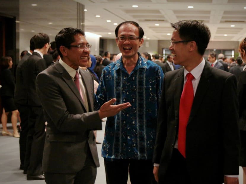 Maliki Osman, Yee Jenn Jong and Gerald Giam share a light moment at the reception after the opening session of the 13th Parliament. Photo: Jason Quah