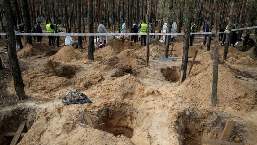 Ukrainians search grave site for relatives after Russians driven out 
