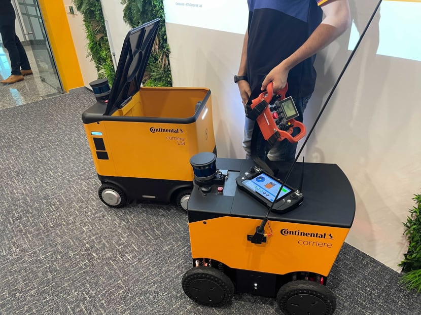 Robots pictured above that will be put on trial to make food deliveries are weather-resistant, can travel at up to 20km/h, clear security turnstiles and take the lifts in buildings on their own.