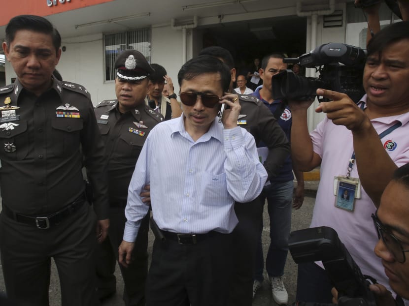 Doctor Sompob Sansiri was escorted by Thai police at a police station in Bangkok on Oct 24, 2014. He is facing charges of causing death by reckless act. Photo: AP