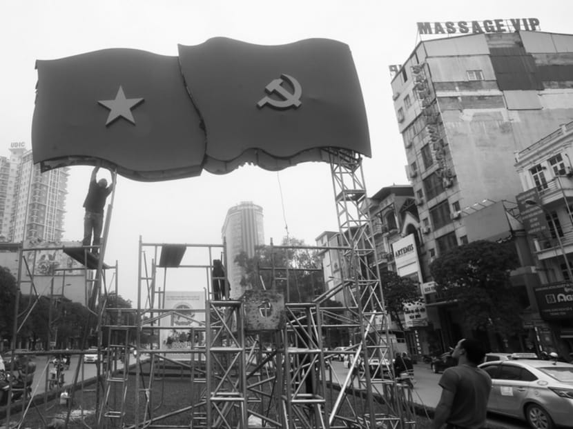 Workers putting up the national and communist flags ahead of the Communist Party congress. Photo: Reuters