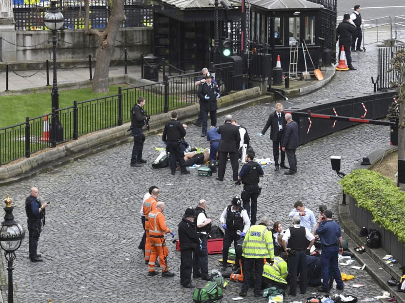Emergency services attending to the attacker (top) and the stabbed police officer (bottom) outside the Palace of Westminster. Both men later died. Photo: Press Association