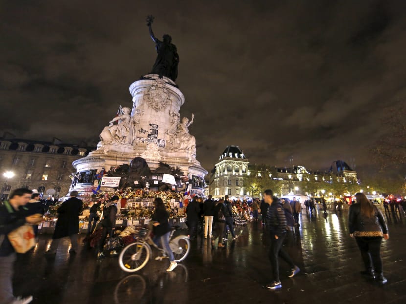 People pay tribute to victims at the Place de la Republique in Paris, France, on Nov 19, 2015, after last Friday's series of deadly attacks in the French capital. Photo: Reuters