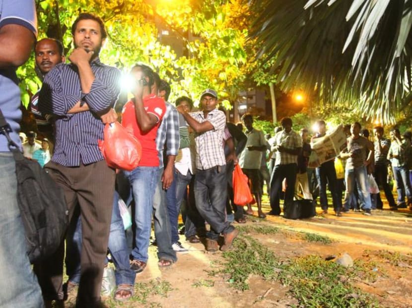 Foreign workers queueing for buses at Little India. Photo: Ernest Chua.