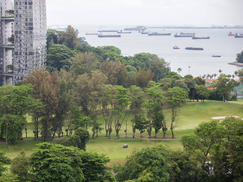A view of part of Keppel Club's golf course facing the waters of Singapore Strait, with a tower block from Reflections at Keppel Bay condominium estate on the left.