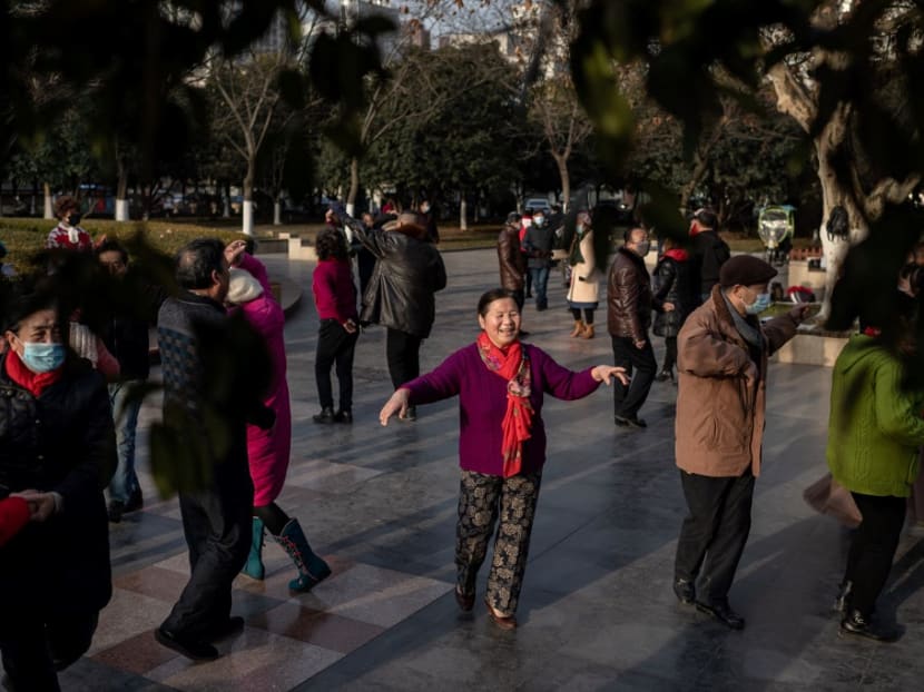 Elderly people dance in a public area along the Yangtze River in Wuhan on Jan 11, 2021.