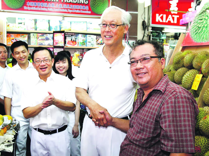 ESM Goh Chok Tong (centre) posing for a photograph with a resident during a walkabout in Marine Parade GRC with his team, from left, Brigadier-General Tan Chuan Jin, Mr Seah Kian Peng and Ms Tin Pei Ling. TODAY file photo