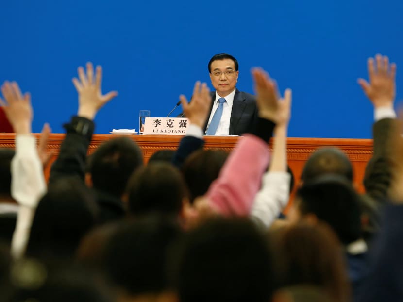 Premier Li Keqiang taking questions at his annual news conference after the closing ceremony of China’s National People’s Congress in Beijing, yesterday. He said that talk of a sharp slowdown in China’s economy should stop. PHOTO: REUTERS