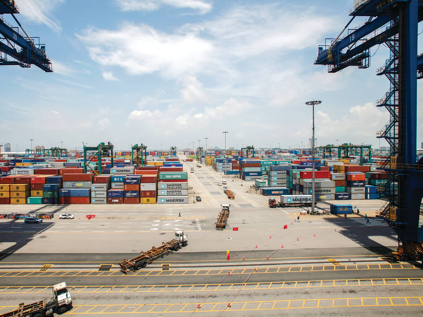 Containers being transported at Nansha port in Guangzhou. The IMF has urged China’s policymakers to step up efforts to move the economy away from its over-reliance on investment and exports to drive growth and shift the balance towards consumption. 
PHOTO: REUTERS