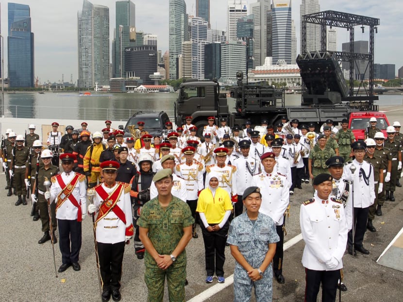 Uniformed personnel participating in the 2014 National Day Parade standing for a group photo at the floating platform shortly after a parade preview for the media. Photo: Don Wong
