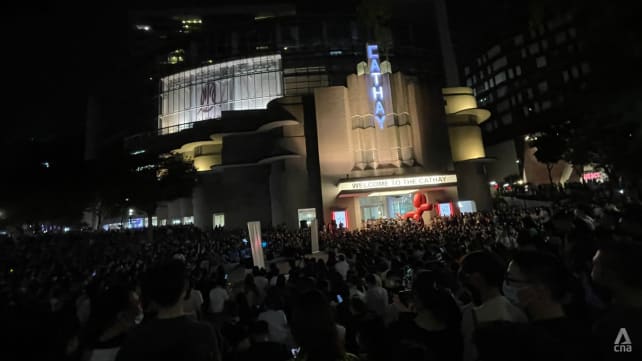 Large crowds outside The Cathay as people gather to watch busker perform