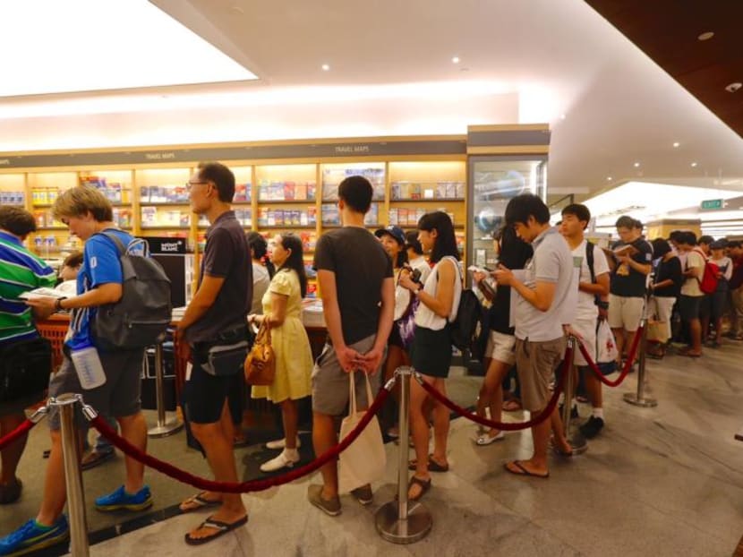 A start-up here — called the iQueue — hopes to cash in on Singapore's national past-time of queueing up by providing professional queueing services. Photo: TODAY