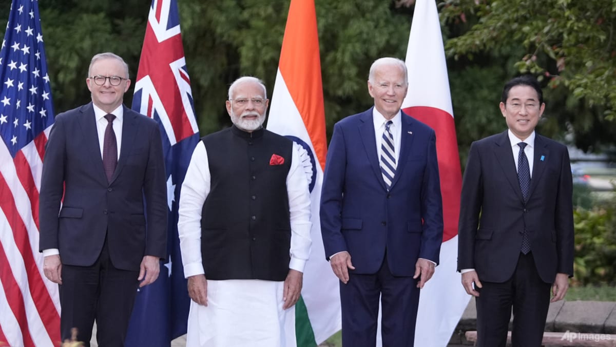 Biden says China ‘testing us’, in hot mic remarks to Quad allies