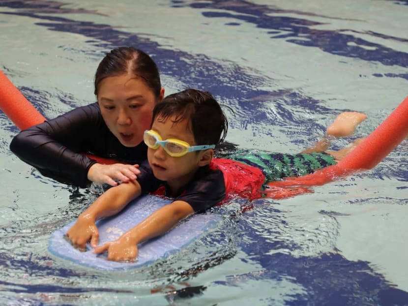 Ms Azura Lo, a physiotherapist, with six-year-old Lucas Mak at a hydrotherapy session at the Heep Hong Society Integrated Service Complex in Sandy Bay.