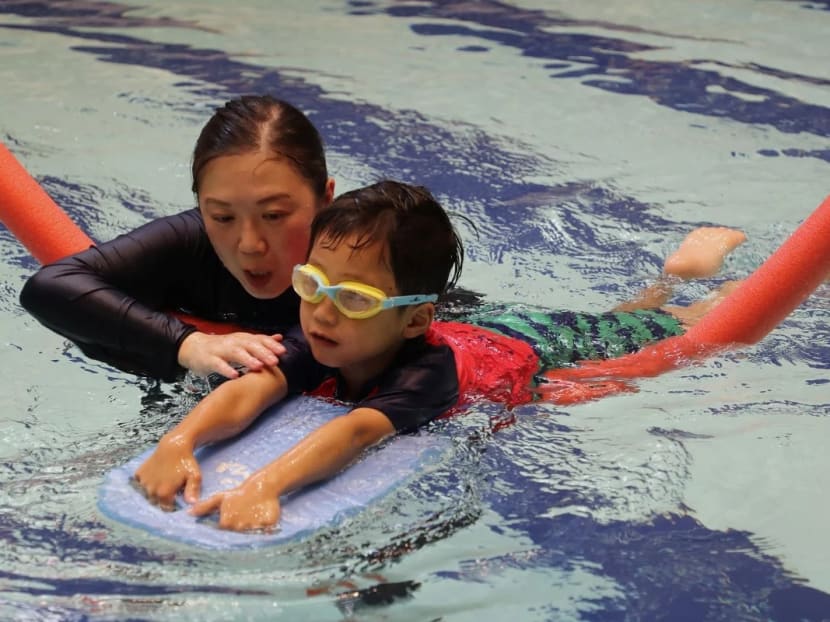 Ms Azura Lo, a physiotherapist, with six-year-old Lucas Mak at a hydrotherapy session at the Heep Hong Society Integrated Service Complex in Sandy Bay. Ms Azura Lo, a physiotherapist, with six-year-old Lucas Mak at a hydrotherapy session at the Heep Hong Society Integrated Service Complex in Sandy Bay.
