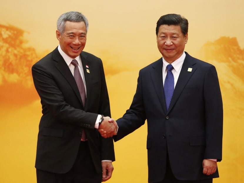 Prime Minister Lee Hsien Loong (L) shakes hands with China's President Xi Jinping during a welcoming ceremony for the Asia-Pacific Economic Cooperation (APEC) summit in Beijing, Nov 11. Photo: Reuters