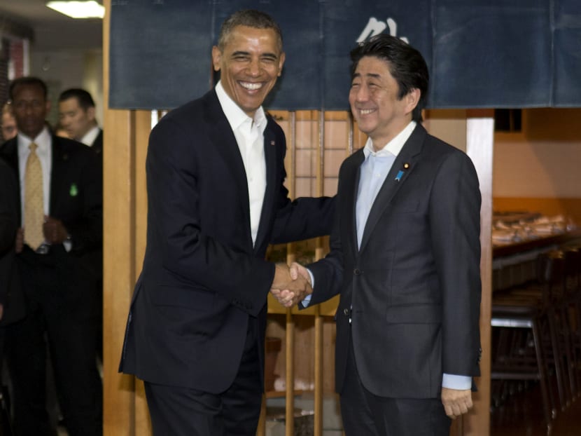 President Barack Obama and Japanese Prime Minister Shinzo Abe shake hands before having dinner at Sukiyabashi Jiro in Tokyo, April 23, 2014.  Photo: AP