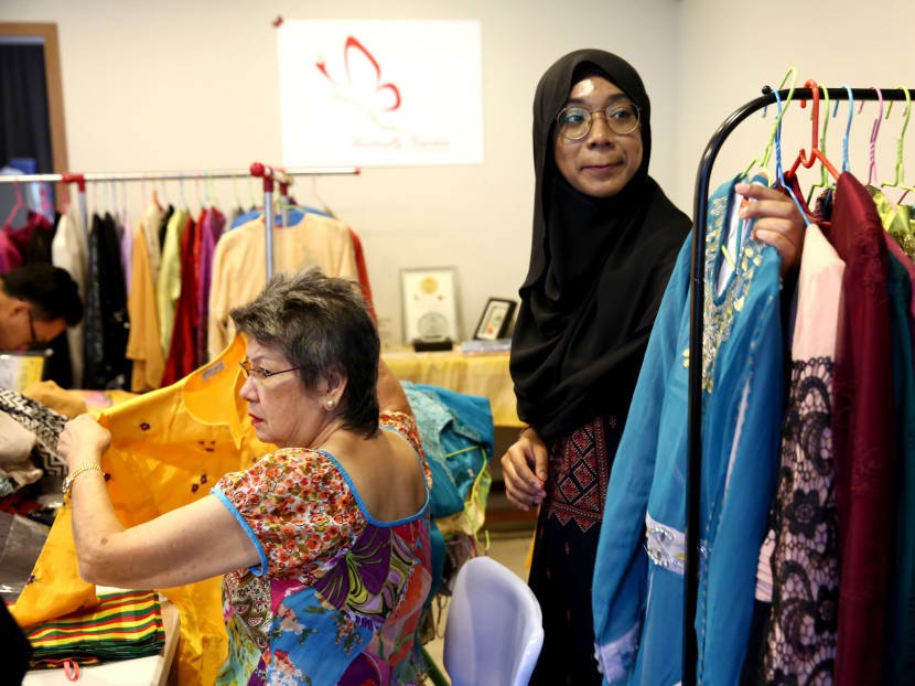 Volunteers in a Residents' Committee (RC) in Tampines Changkat packing pre-loved clothes collected during a donation drive for needy families during the Hari Raya festive season. Photo: Nuria Ling/TODAY