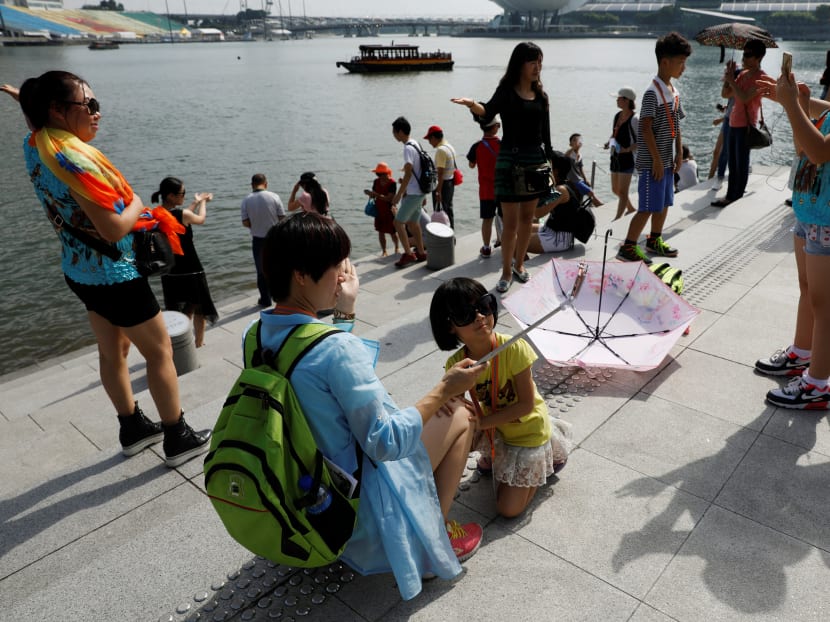Tourists take photos at the Merlion Park in Singapore. Reuters file photo