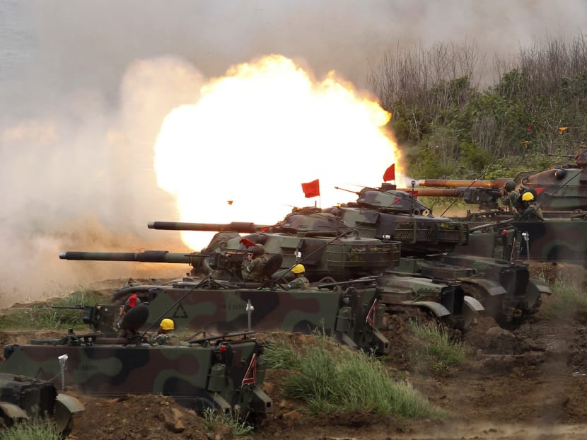 Tanks firing at a target during the annual Han Kuang exercises on the outlying Penghu Islands yesterday. As part of the drills, helicopters fired missiles and jet fighters dropped bombs in the waters off the coast. Photo: AP