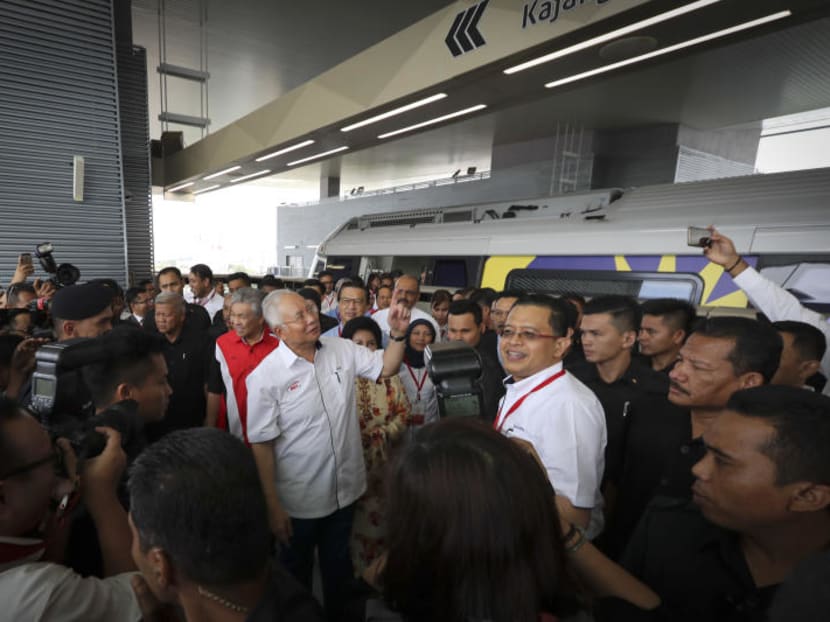 Malaysian Prime Minister Najib Razak (centre) pointing to a Mass Rapid Transit (MRT) station signboard as he arrives at the newly opened MRT Line in Kajang, on the outskirts of Kuala Lumpur on Monday, July 17, 2017. The launch marked a significant milestone in the government's continuous effort to enhance and improve urban public transportation network particularly in the Klang Valley region. Photo: AP Malaysian Prime Minister Najib Razak (centre) pointing to a Mass Rapid Transit (MRT) station signboard as he arrives at the newly opened MRT Line in Kajang, on the outskirts of Kuala Lumpur on Monday, July 17, 2017. The launch marked a significant milestone in the government's continuous effort to enhance and improve urban public transportation network particularly in the Klang Valley region. Photo: AP