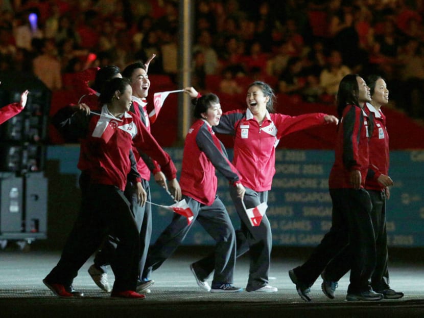 Singapore athletes celebrate a job well done at the closing ceremony yesterday. Photo: Jason Quah