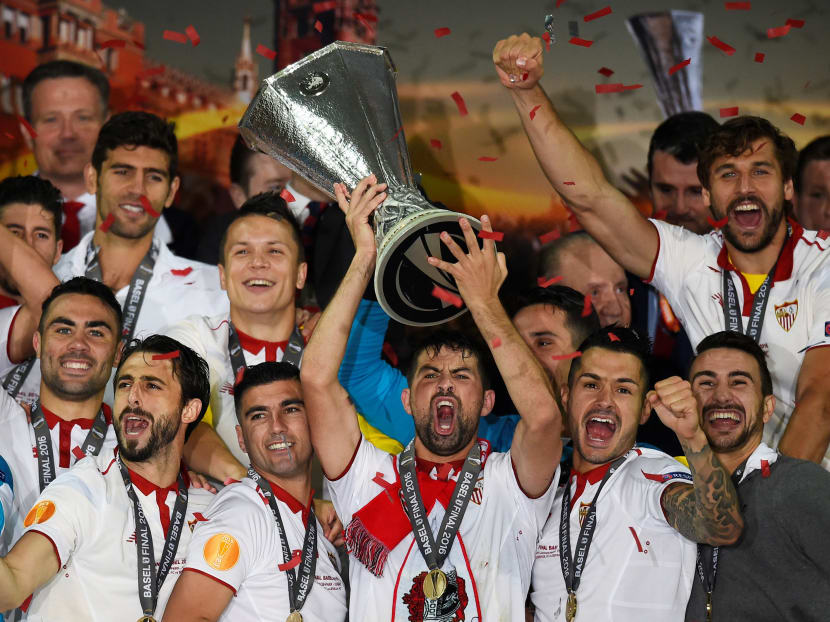 Sevilla's Coke celebrates with the trophy and team mates after winning the UEFA Europa League final. Photo: Reuters