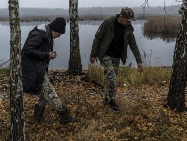 Mr Dmytro Poyedynok and his wife, Mrs Yana Poyedynok, search for mushrooms in the Bucha area of Ukraine on Nov 3, 2022.