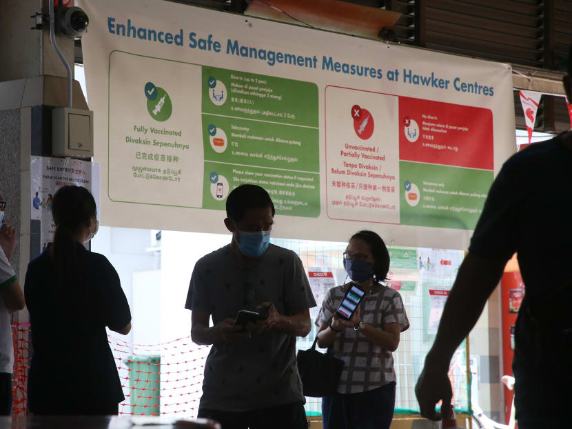 Patrons undergoing checks at the entry point of Ang Mo Kio Central Market & Food Centre on Oct 17, 2021.