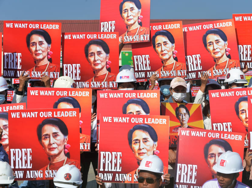 A group of protesting engineers hold up signs calling for the release of detained Myanmar civilian leader Aung San Suu Kyi during a demonstration against the military coup in Naypyidaw on Feb 15, 2021.