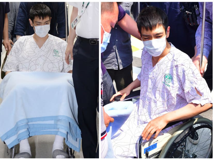 South Korean pop star T.O.P (on wheel-chair), rapper of K-pop boy band Big Bang, emerges from the intensive care unit of a hospital in Seoul on June 9, 2017. South Korean pop star T.O.P regained consciousness on June 9 after spending three days in a critical condition in intensive care at a Seoul hospital following an apparent drugs overdose. Photo: AFP