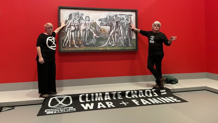 Protesters glue hands to cover of Picasso painting Protesters glue hands to cover of Picasso painting
