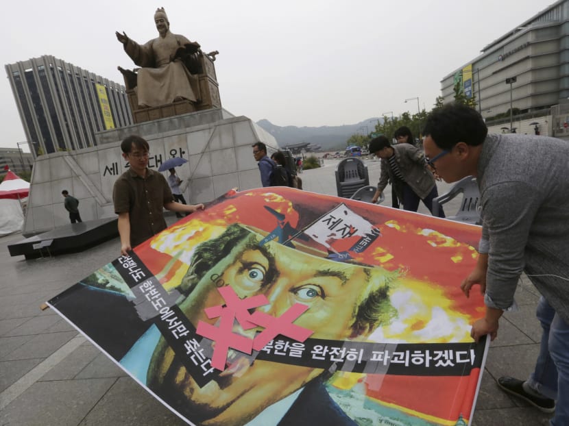 South Korean protesters carrying a banner depicting US President Donald Trump during a rally near the US Embassy in Seoul yesterday to denounce the United States policy against North Korea. Some long-time observers said it would be wise not to overreact to Pyongyang’s aggressive statements. Photo: AP