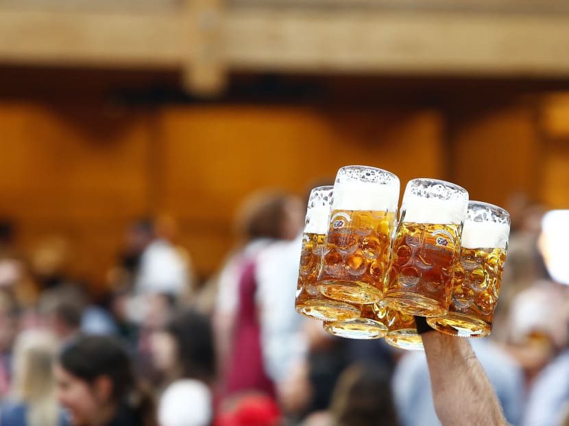 A waiter carries mugs of beer. Reuters file photo