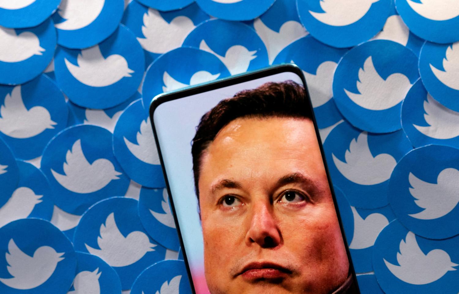 An image of Mr Elon Musk is seen on smartphone placed on printed Twitter logos in this picture illustration taken on April 28, 2022.
An image of Mr Elon Musk is seen on smartphone placed on printed Twitter logos in this picture illustration taken on April 28, 2022.