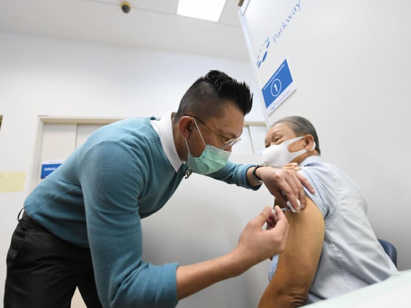 Taxi driver Tham Yuet Kok (right), 72, was among the first taxi drivers to receive the Covid-19 vaccination on Feb 23, 2021.