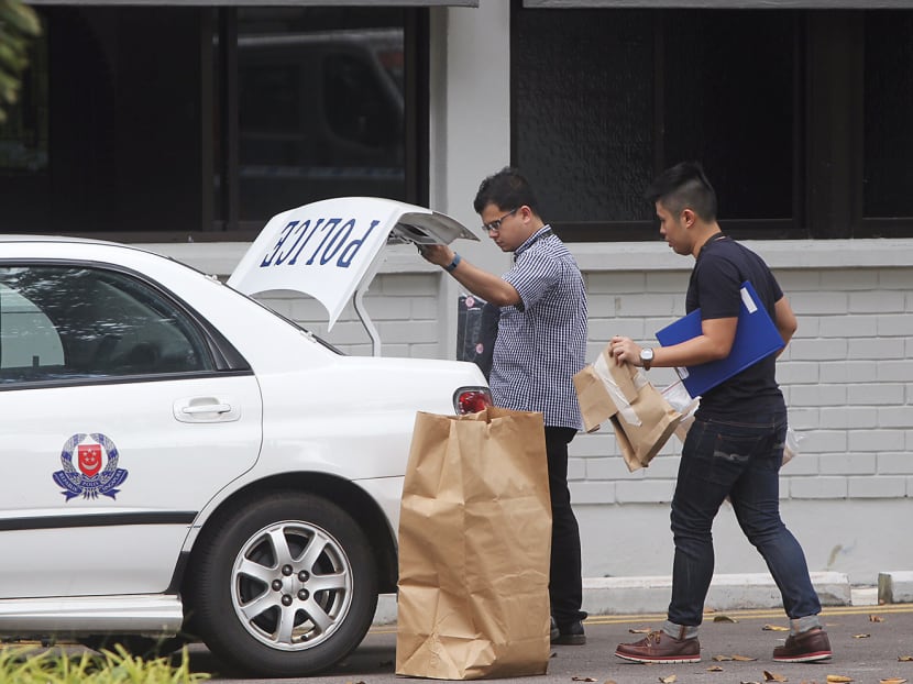 Police loading evidence onto a patrol car while investigations carry on at Park View Mansions, Yuan Ching Road, where three people were taken to hospital with injuries. Photo: Don Wong