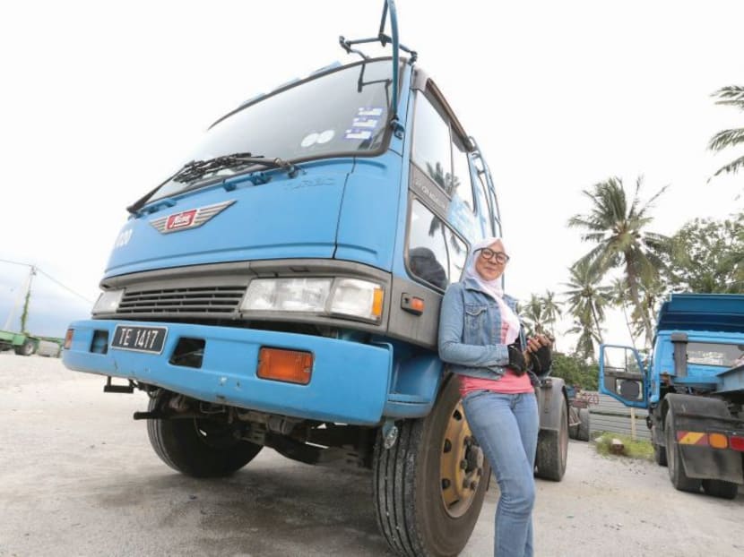 Rokiah poses in front of her 10-wheeler truck at the Permatang Pauh truck depot in Butterworth. Photo: Malay Mail Online