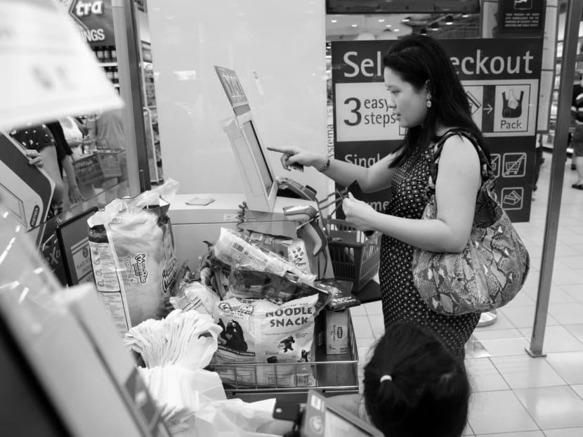 A woman at a self-checkout machine at Fairprice Xtra at nex shopping mall on Sunday. Using self-service technology can instil a sense of being in control and independent. TODAY File Photo