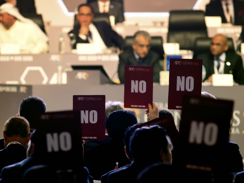 Members of the AFC holding up their "no" vote. Photo: AFP