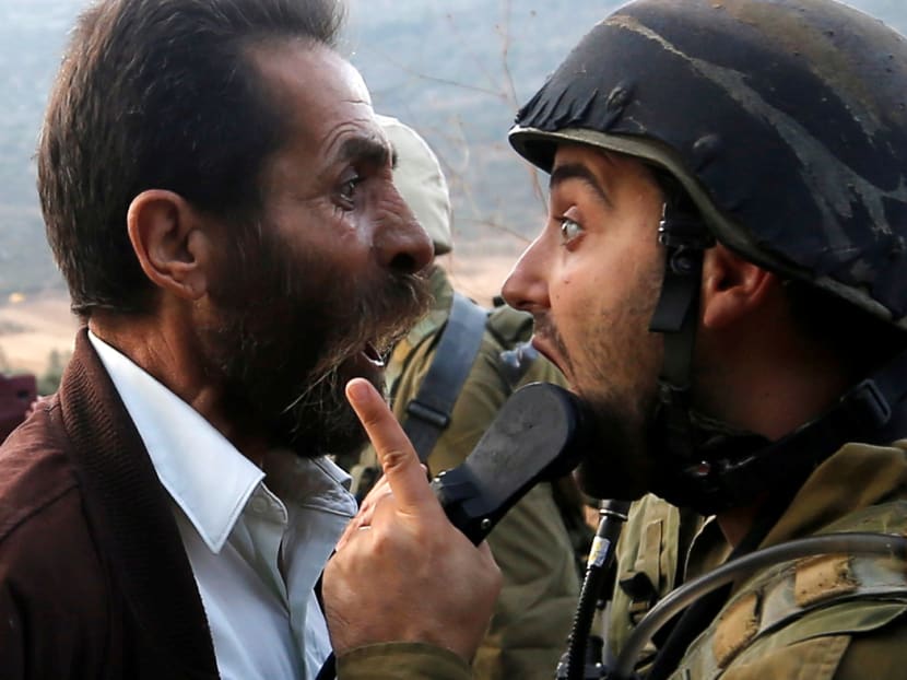 Photo of the day: A Palestinian man and an Israeli soldier arguing during clashes over an Israeli order to shut down a Palestinian school near Nablus in the occupied West Bank on Monday (Oct 15).