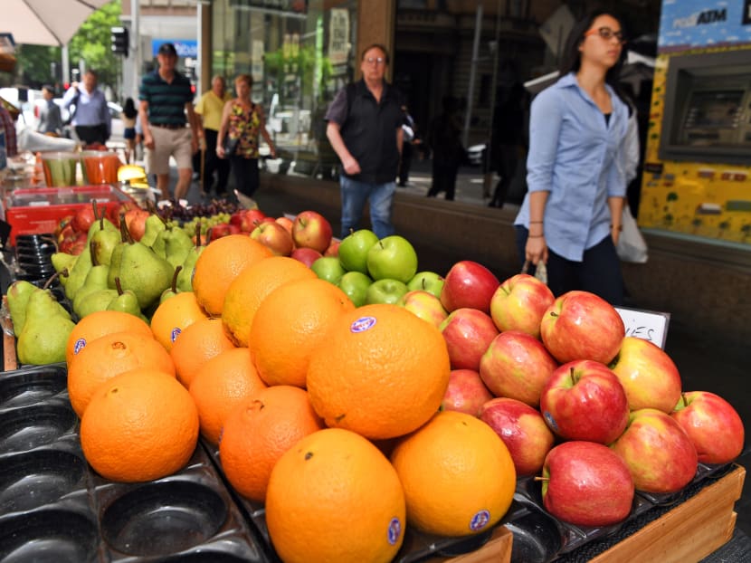 People walk past a fruit stall in Sydney's central business district in this November 29, 2016 file photo. Photo: AFP